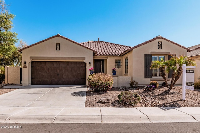 mediterranean / spanish-style home with a garage