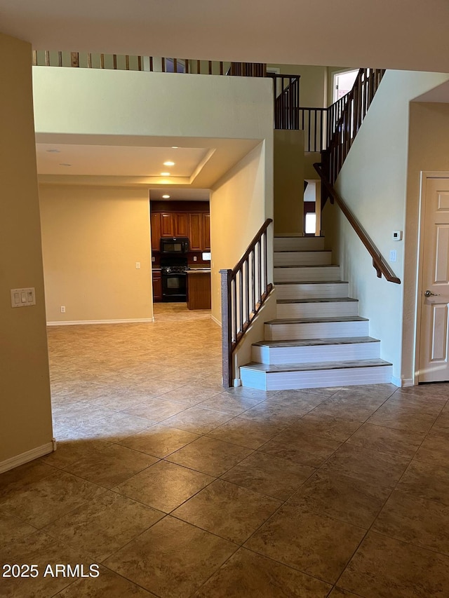 staircase featuring baseboards