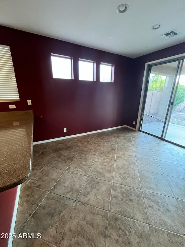 tiled spare room with visible vents, recessed lighting, baseboards, and plenty of natural light