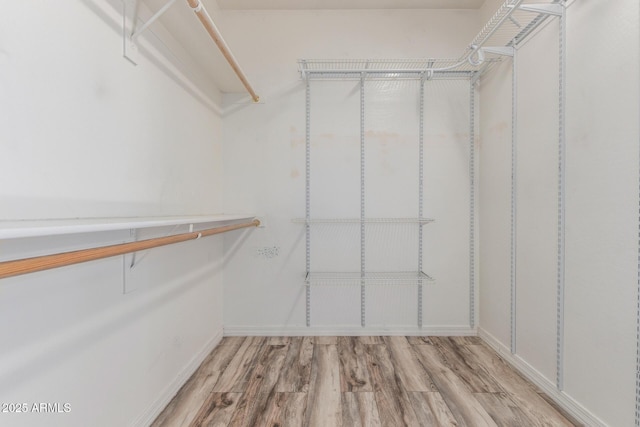 walk in closet featuring light wood-style floors