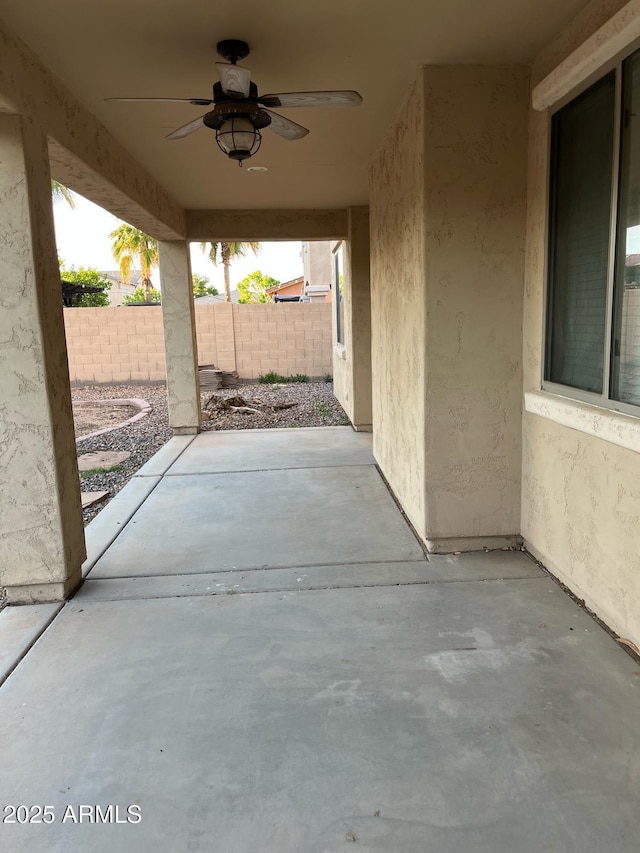 view of patio / terrace featuring ceiling fan and fence
