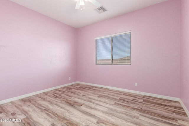 empty room with a ceiling fan, baseboards, visible vents, and light wood finished floors