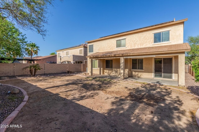 back of property with a patio, a fenced backyard, and stucco siding