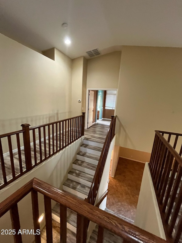 stairs with baseboards, recessed lighting, and visible vents