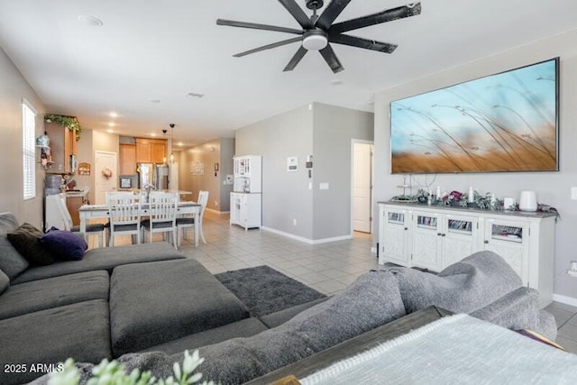 living area featuring baseboards and light tile patterned floors