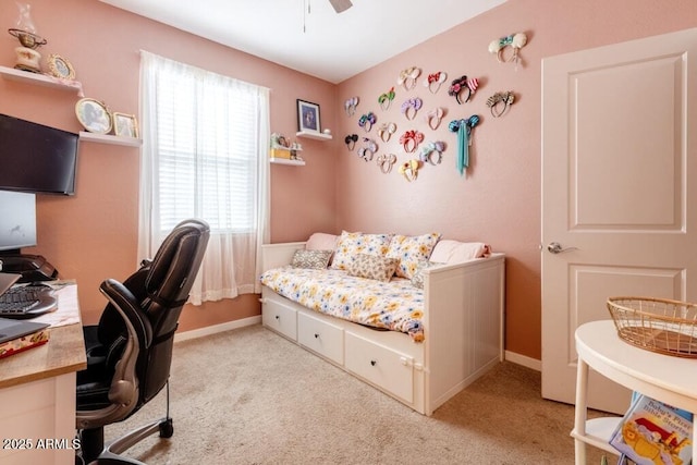 bedroom with light carpet, baseboards, and a ceiling fan