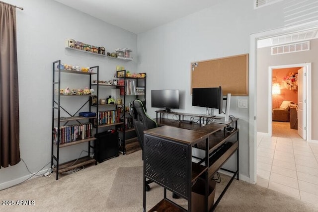 office with light carpet, light tile patterned floors, and visible vents