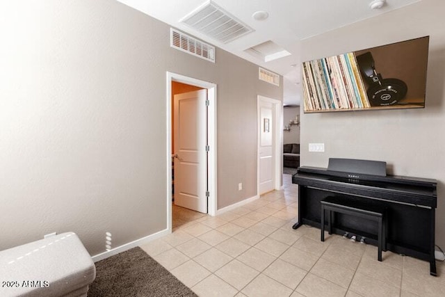 living area featuring visible vents, baseboards, and light tile patterned floors