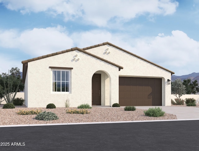 mediterranean / spanish-style home with driveway, an attached garage, and stucco siding