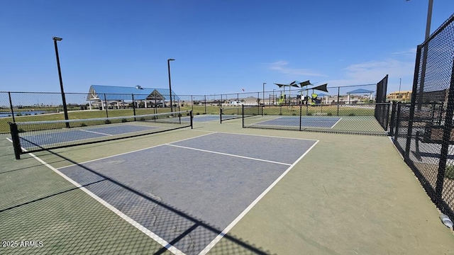 view of tennis court with fence