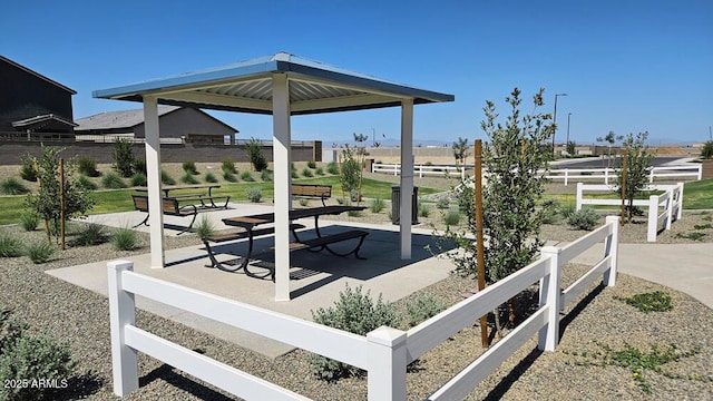 view of home's community with fence, a patio, and a gazebo