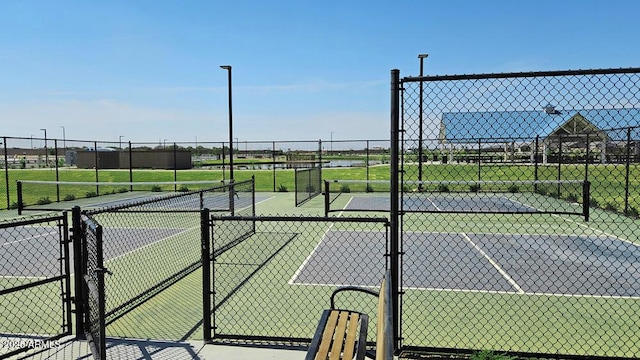 view of tennis court featuring fence