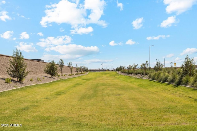 view of yard featuring a rural view and fence