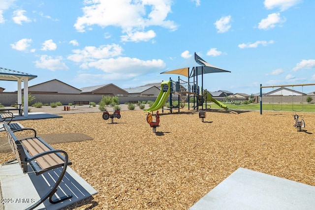 communal playground featuring a patio area and fence