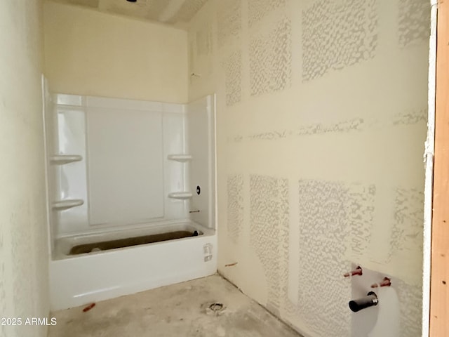 full bath with concrete flooring and tub / shower combination