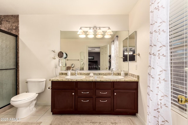 bathroom with a shower with shower door, tile patterned floors, vanity, and toilet