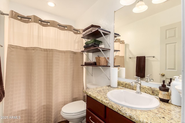 bathroom featuring toilet and vanity