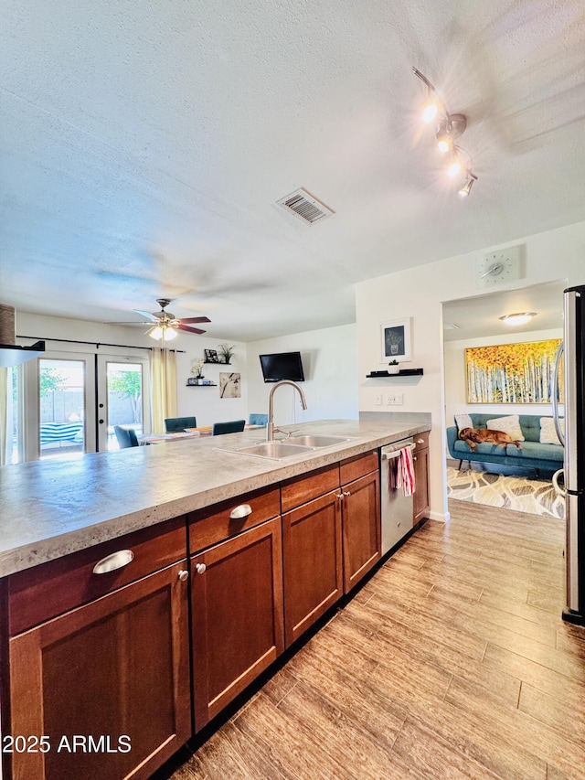 8343 E Edward Ave, Scottsdale, AZ 85250 - kitchen with appliances with stainless steel finishes, a textured ceiling, ceiling fan, light countertops, and brown cabinetry