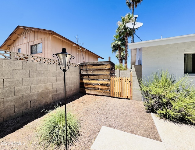 8343 E Edward Ave, Scottsdale, AZ 85250 - view of home's exterior with a gate and board and batten siding