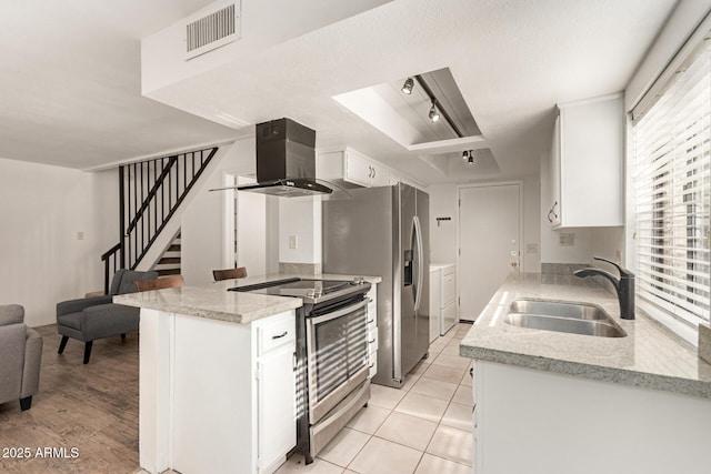 8841 S 48th St Unit 1, Phoenix, AZ 85044 - kitchen with a sink, appliances with stainless steel finishes, washing machine and dryer, wall chimney range hood, and a tray ceiling