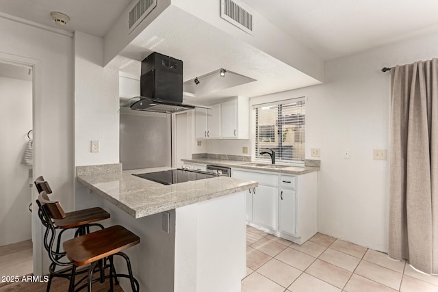 8841 S 48th St Unit 1, Phoenix, AZ 85044 - kitchen with ventilation hood, a sink, black electric stovetop, a breakfast bar area, and white cabinetry