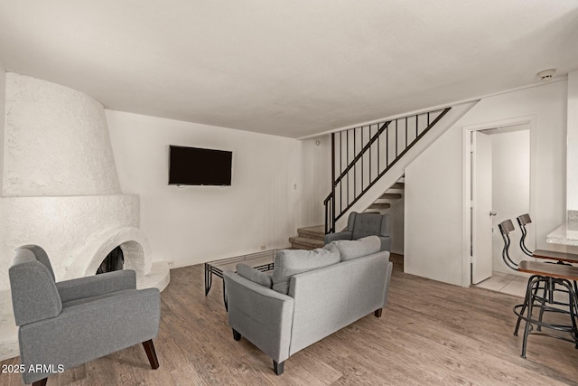 8841 S 48th St Unit 1, Phoenix, AZ 85044 - living room with stairway, light wood-style floors, and a fireplace with raised hearth