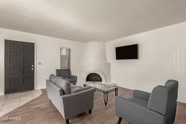 8841 S 48th St Unit 1, Phoenix, AZ 85044 - living room with a tile fireplace and light wood-type flooring