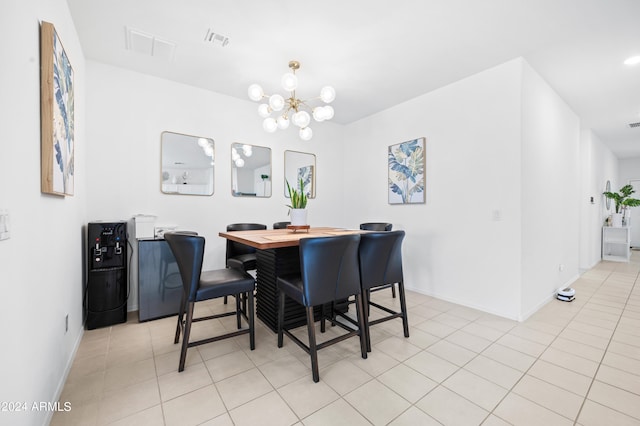 dining space with light tile patterned floors and a notable chandelier