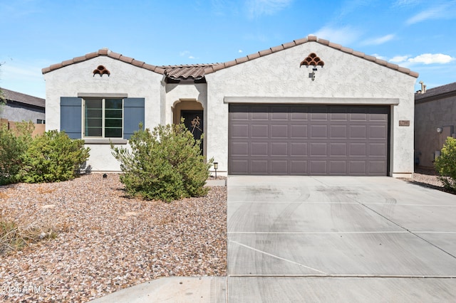 mediterranean / spanish-style home with a garage