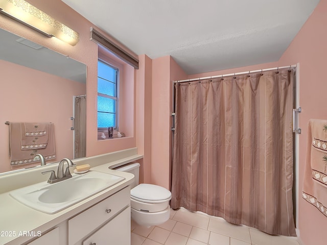 bathroom with toilet, tile patterned flooring, and vanity