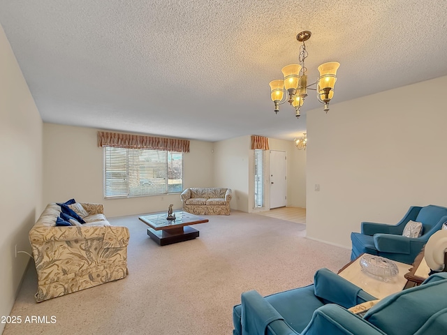 living area featuring a chandelier, a textured ceiling, and carpet flooring