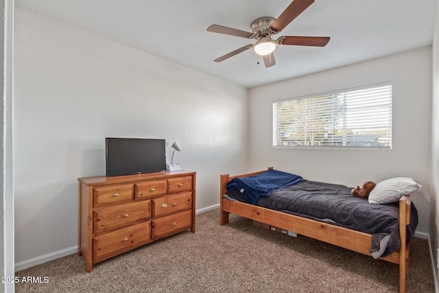 carpeted bedroom with ceiling fan and baseboards