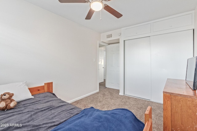 bedroom featuring a closet, light colored carpet, visible vents, ceiling fan, and baseboards