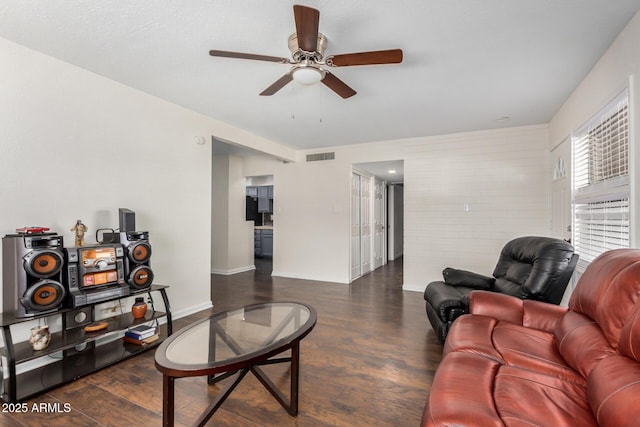 living room with ceiling fan, dark wood-style flooring, visible vents, and baseboards