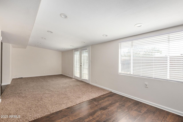 spare room with dark wood-style floors, recessed lighting, and baseboards