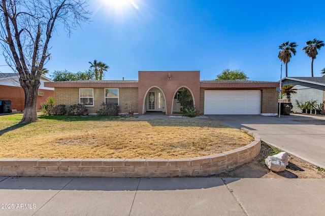 view of front of home featuring a garage and a front yard