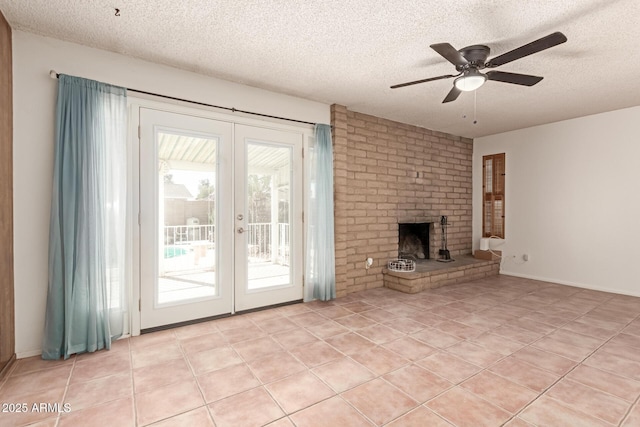 unfurnished living room featuring a brick fireplace, light tile patterned floors, and a textured ceiling