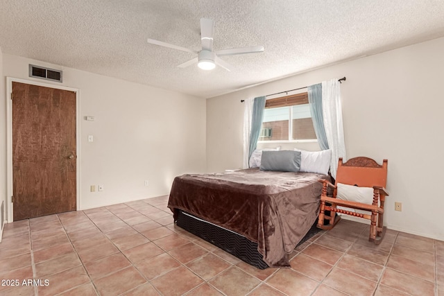 bedroom with light tile patterned floors, a textured ceiling, and ceiling fan