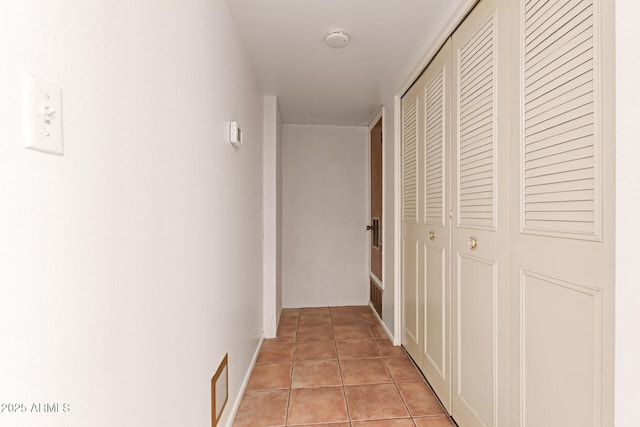 hall with light tile patterned floors