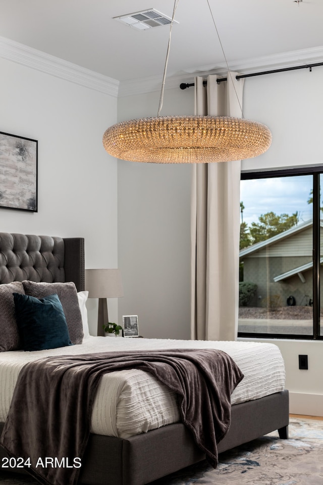 bedroom with crown molding and hardwood / wood-style flooring