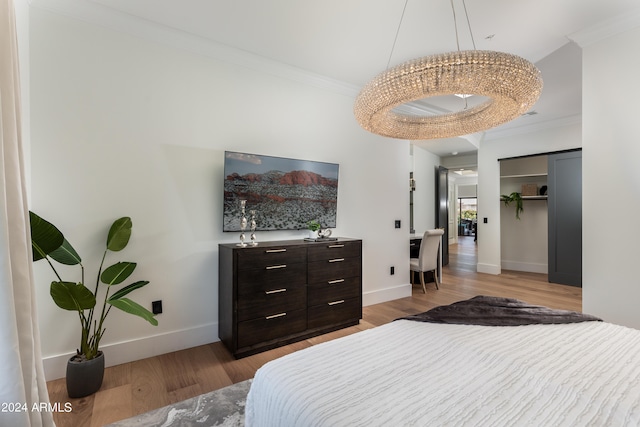 bedroom with ornamental molding, hardwood / wood-style flooring, and a closet