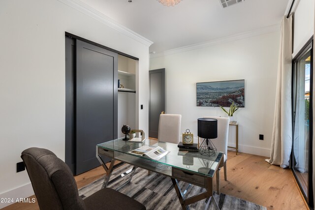 office space with crown molding and light hardwood / wood-style floors