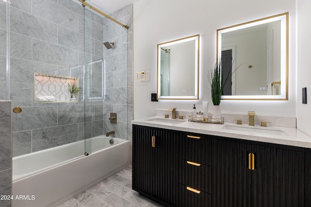 bathroom featuring tiled shower / bath and vanity