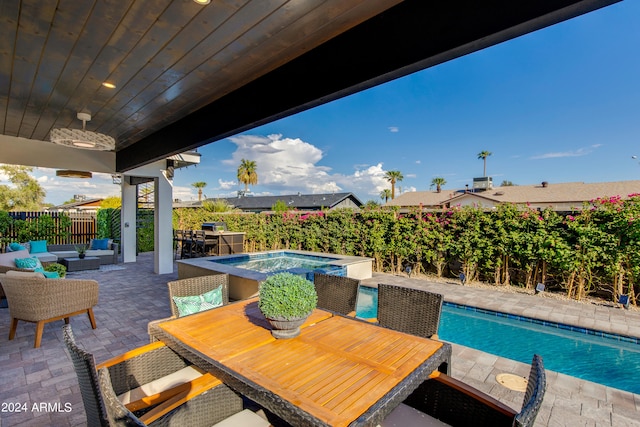 view of swimming pool with outdoor lounge area, a patio, and an in ground hot tub