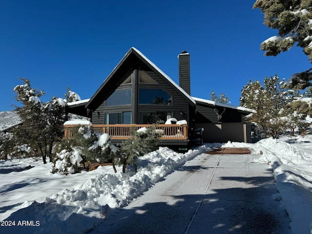 snow covered property featuring a deck