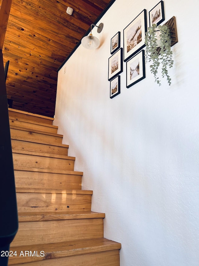 staircase with wooden ceiling