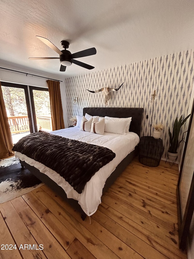 bedroom with ceiling fan, hardwood / wood-style flooring, and french doors