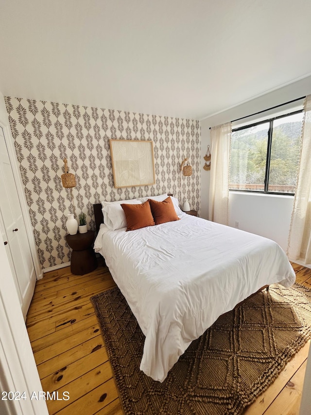 bedroom featuring a closet and light hardwood / wood-style flooring