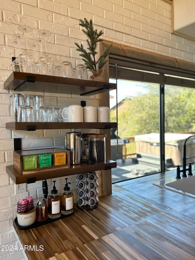 interior space featuring brick wall and plenty of natural light