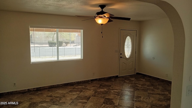 entrance foyer with ceiling fan